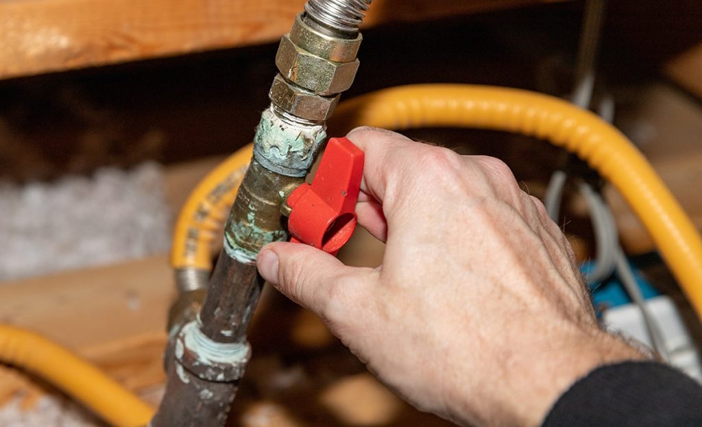 Close Up Of Hand Holding Gas Line