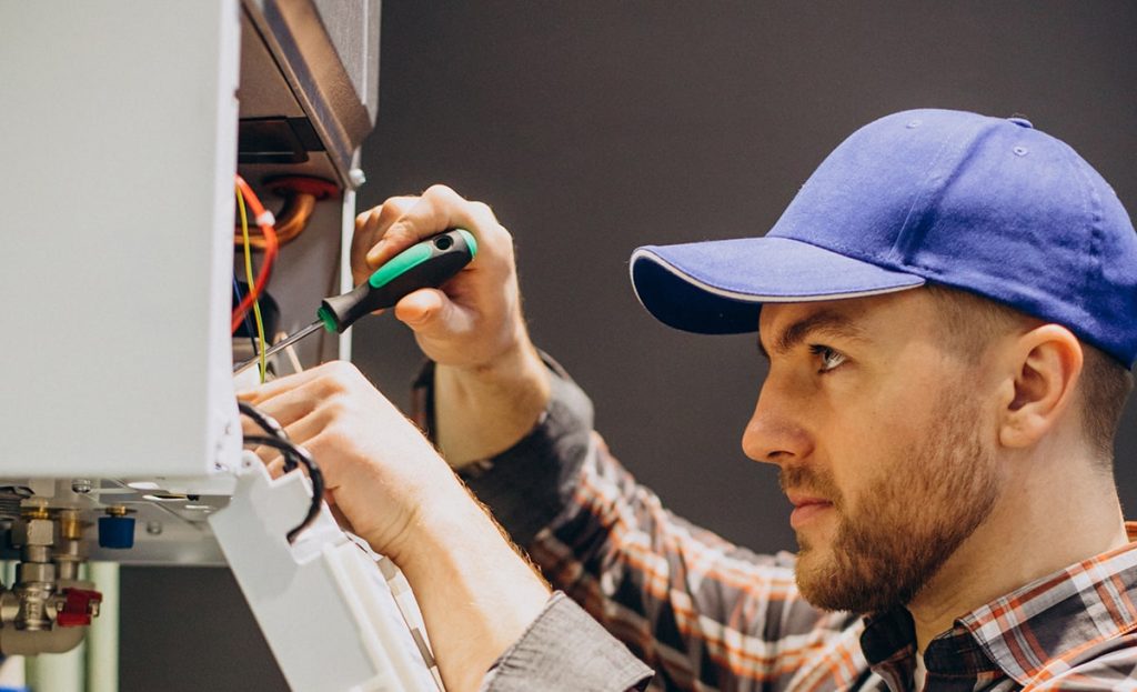 Technician Adjusting House Heating System