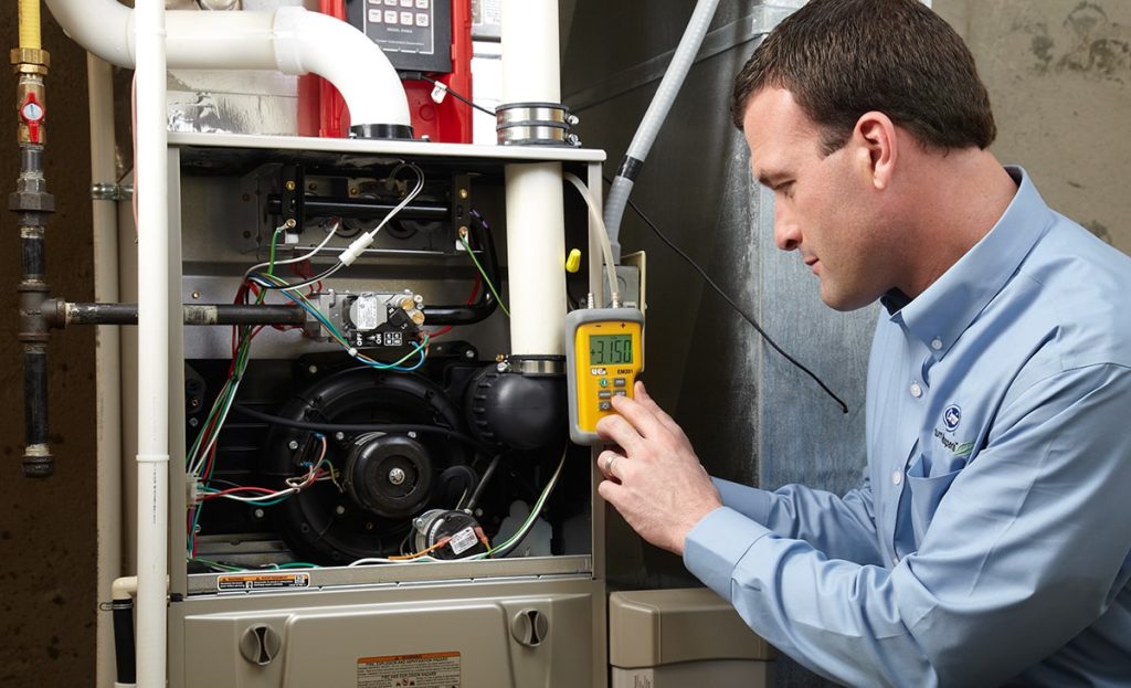 Technician Doing Maintenance On Heater