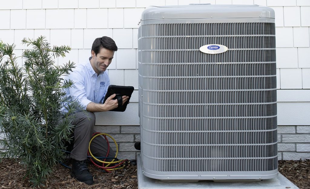 Technician Doing Maintenance On Outdoor Air Conditioner