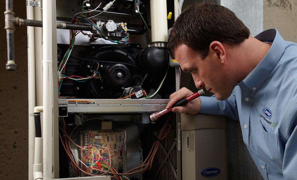 Technician Holding Red Flashlight Inspecting Heater And Wires