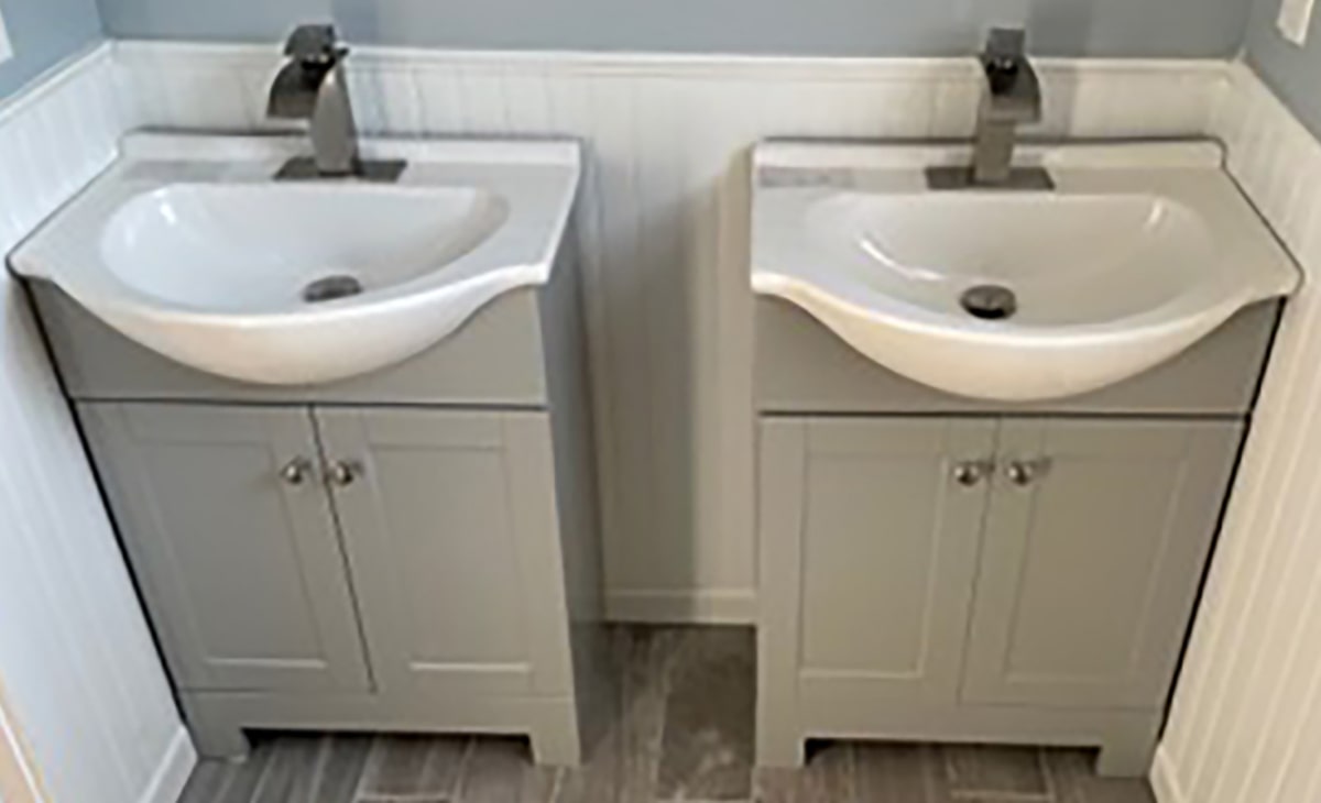 Two Sinks On Grey Cabinet Stands In Bathroom